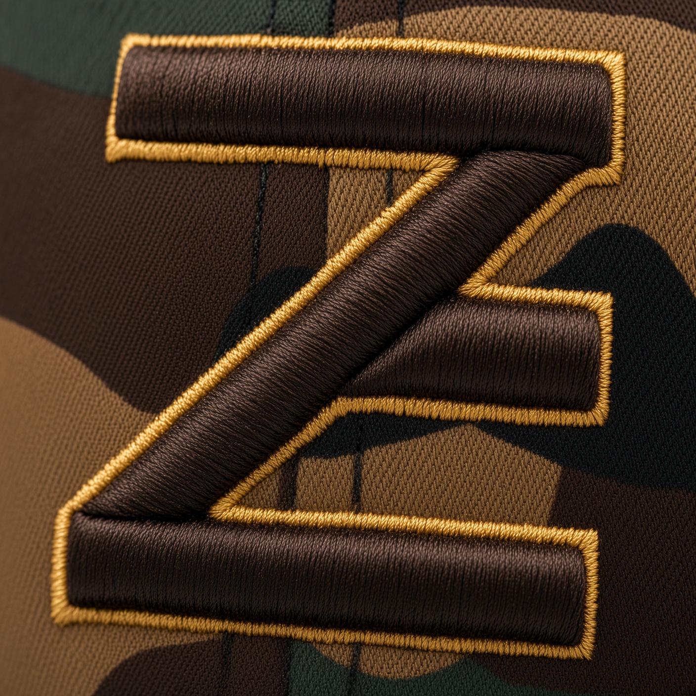 Close-up of the brown and gold embroidered Z